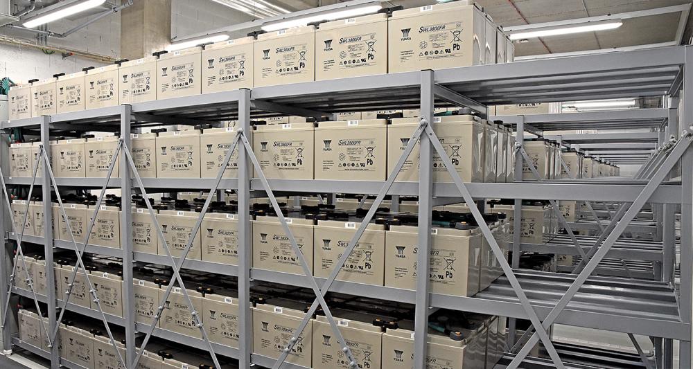 Image of a satellite dish with red light in a desert scene at dusk